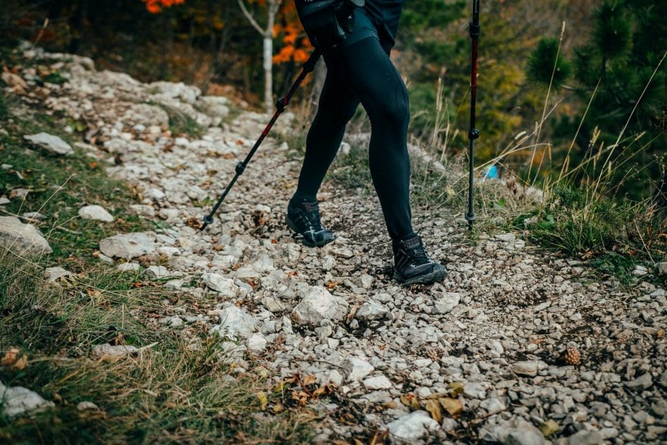 Woman hiking in trail of stones